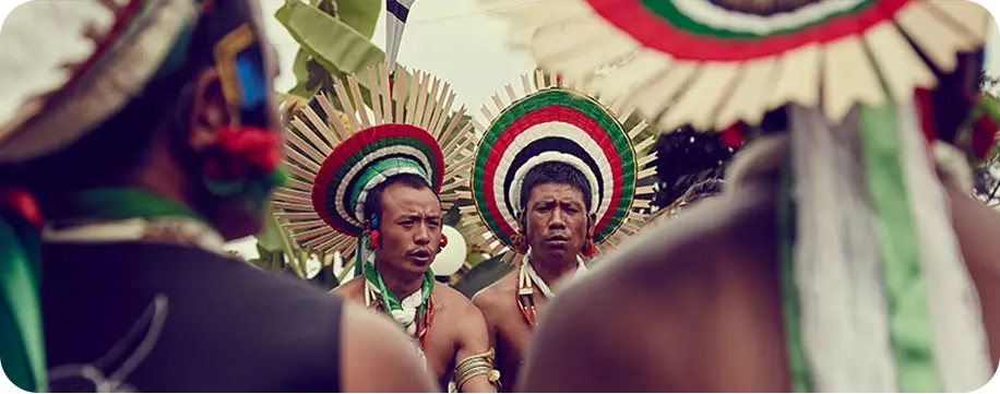 2 men in tribal, traditional headwear.