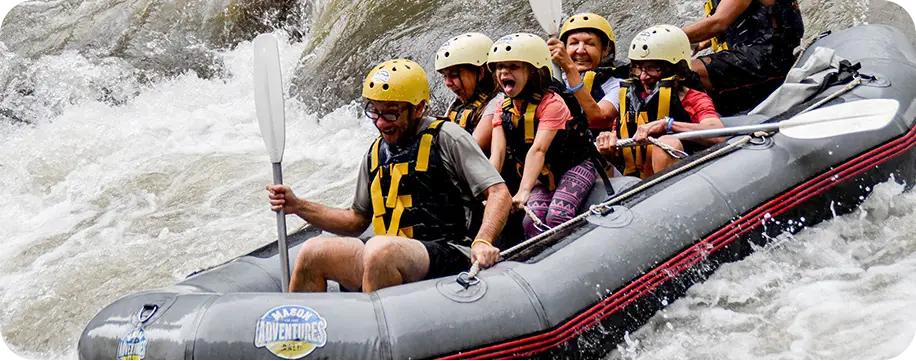 a 'family' of 6 people white water rafting, a young girl is screaming.